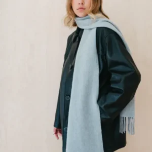 Luxurious TBCo Light Grey Melange Cashmere Scarf with fringe draped elegantly over dark winter coat, showcasing soft texture