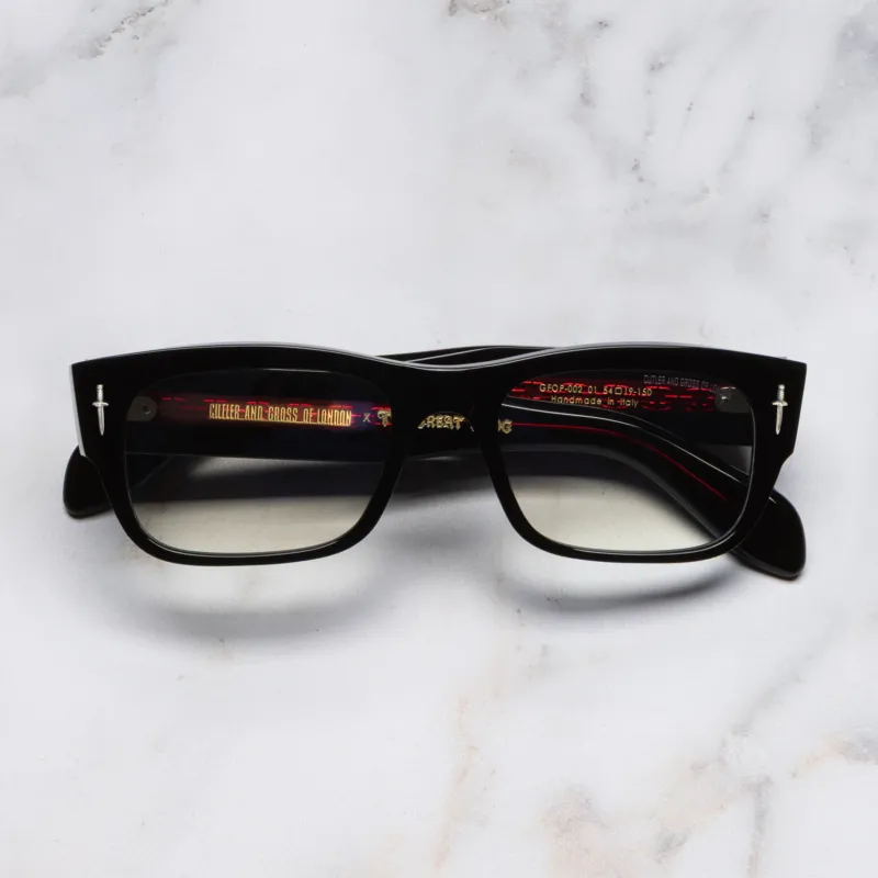 An image of the The Great Frog Dagger Square Optical Glasses in Black frame frontal view with arms closed marble background