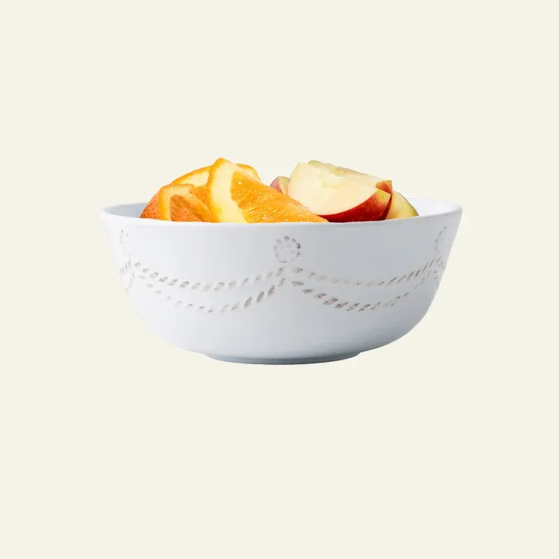 Juliska Berry & Thread white melamine cereal bowl with embossed garland detail, filled with fruit.