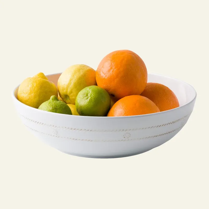 Juliska Berry & Thread white melamine serving bowl filled with fresh citrus fruit.