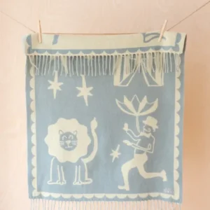 Soft blue and buttermilk yellow Lambswool Baby Blanket in Circus Jacquard by TBCo with playful fringe detailing