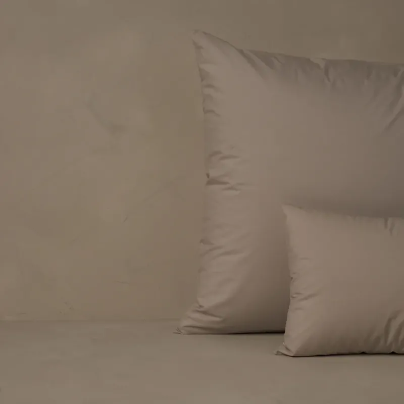 LETTO Retiring Classic Percale decorative case in taupe on a made bed.