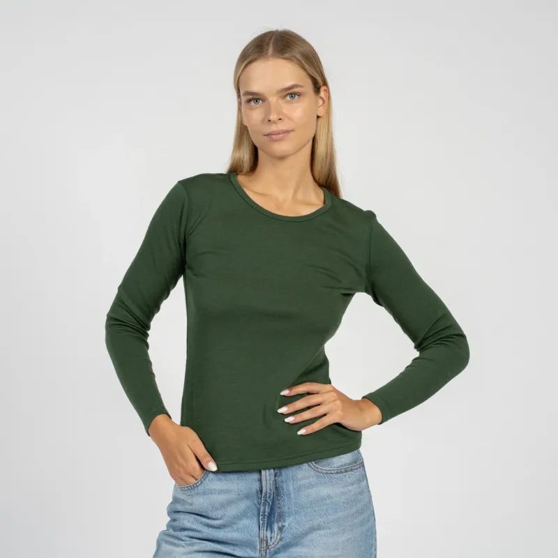 The menique women's merino wool dark green long sleeve top matched with classic light blue jeans, from the front.