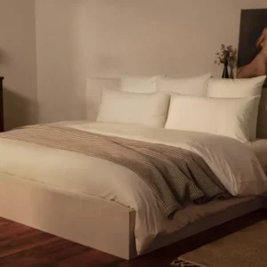 LETTO Giza Reserve Percale ivory duvet cover on made bed with linen throw accent.