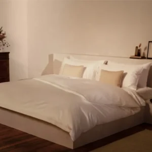 LETTO Giza Reserve Sateen duvet cover in white on a styled bed with champagne accent pillows.