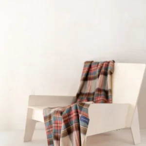TBCo Lambswool Small Blanket in Stewart Dress Antique Tartan draped elegantly over white chair showing traditional plaid pattern