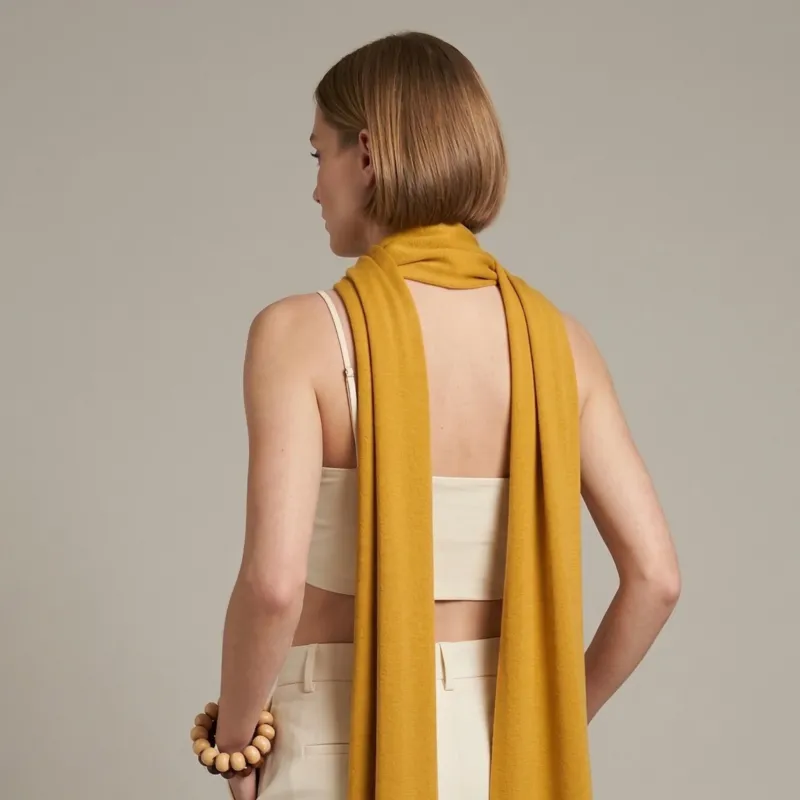 Woman wearing yellow merino wool scarf soft lightweight breathable wrap for all seasons