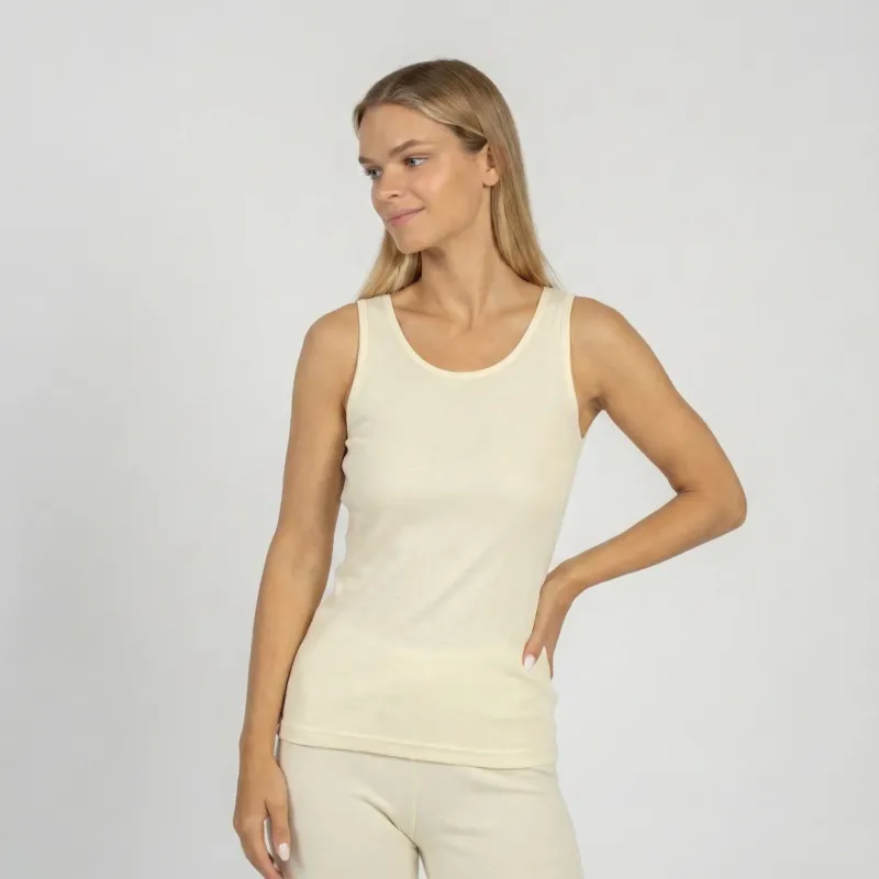 Woman wearing natural Merino wool tank top and leggings, breathable thermal underwear for layering