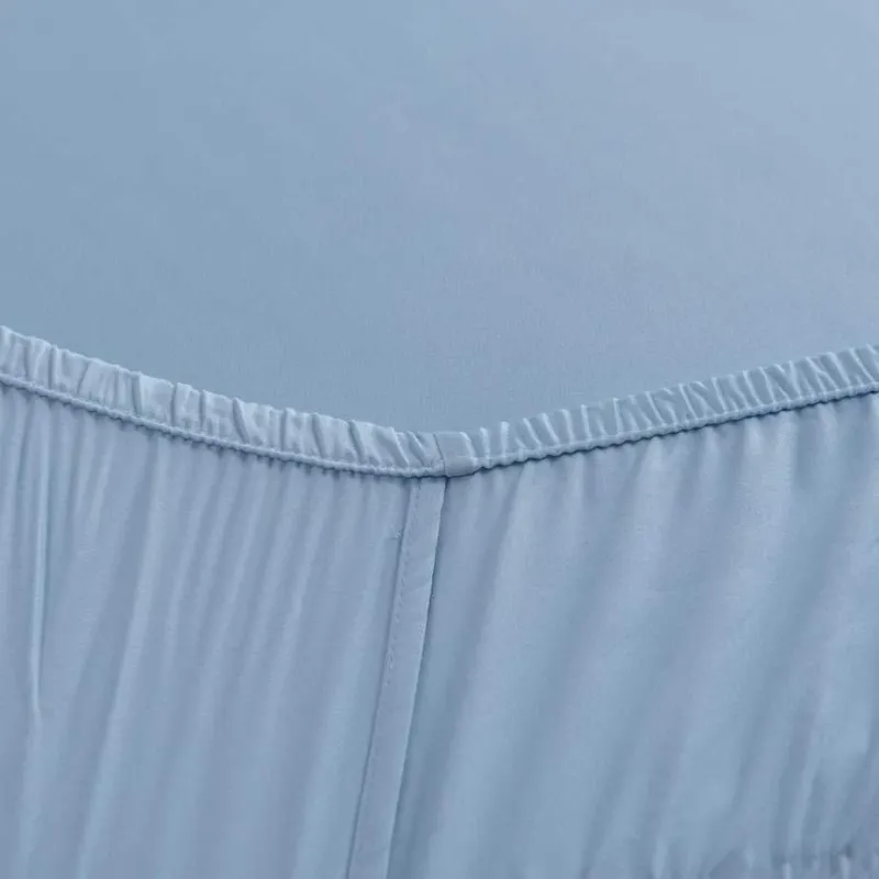 Close-up of the stitched elastic hem on the Sky Blue bamboo fitted sheet