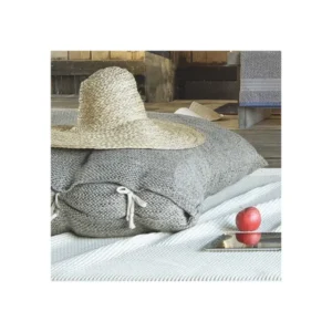 Leitner Carasco firm decorative pillow in grey chunky knit with white ties and straw hat.