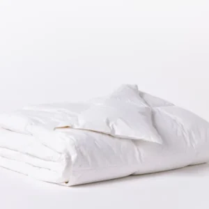 Coyuchi Lightweight Down duvet insert in white, neatly folded showing lofty fill.