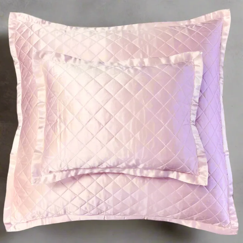 Kumi Kookoon quilted silk pillow sham in blush with diamond stitching and satin border.