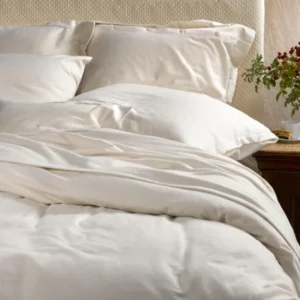 SDH The Purists Flannel fitted sheet in ivory on a made bed with pillows.